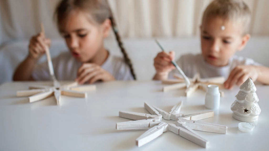 Kids Painting Christmas Snowflakes from Clothespin