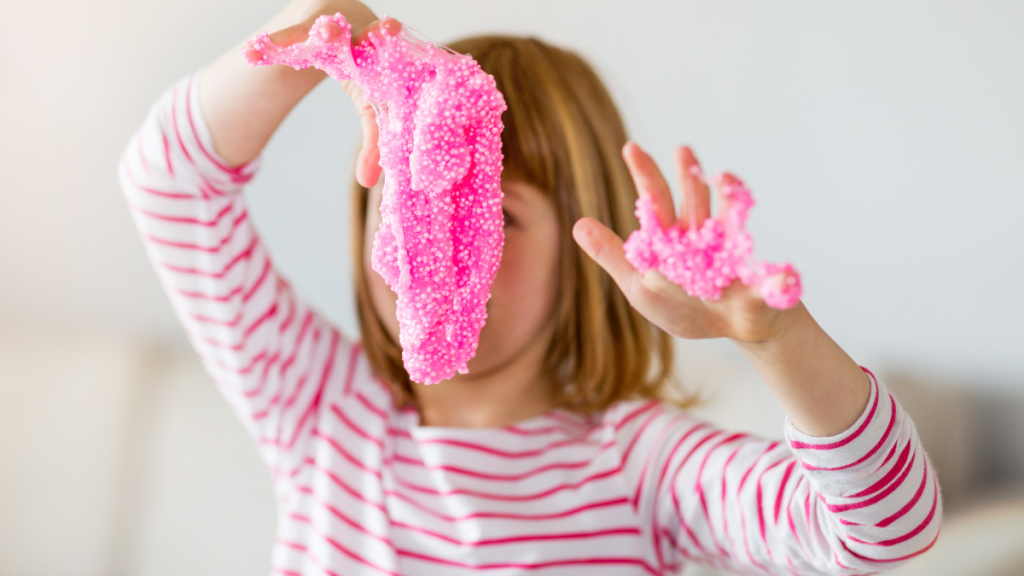 Little girl making homemade slime toy