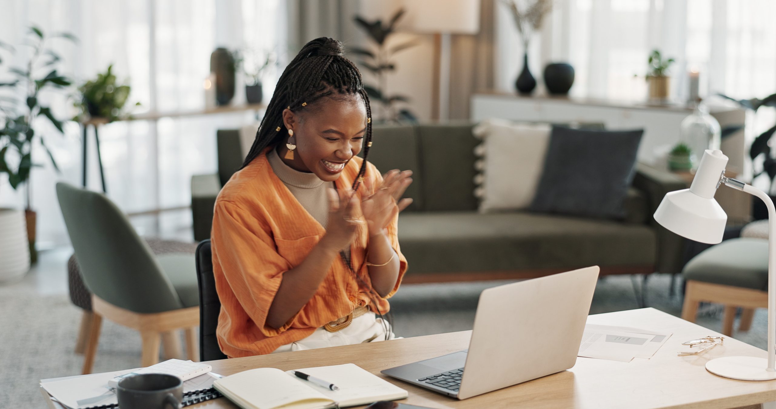 Black woman, success in home office and celebration at laptop for remote work, social media or excited blog. Happy girl at desk with computer for winning email, achievement and good news in freelance.