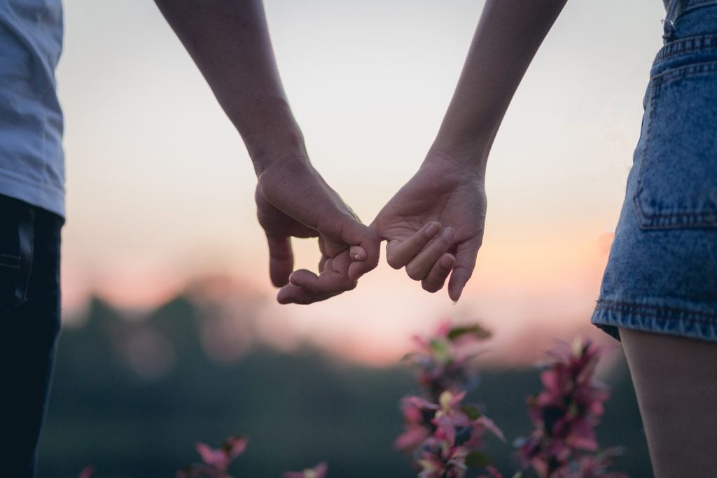 Couple holding hands.